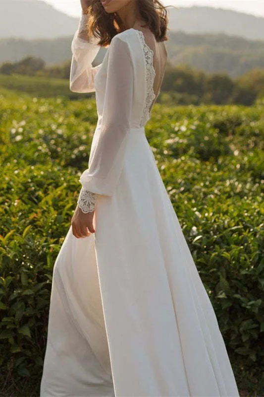 Robe de mariée en mousseline à manches longues et dos nu avec poignets en dentelle