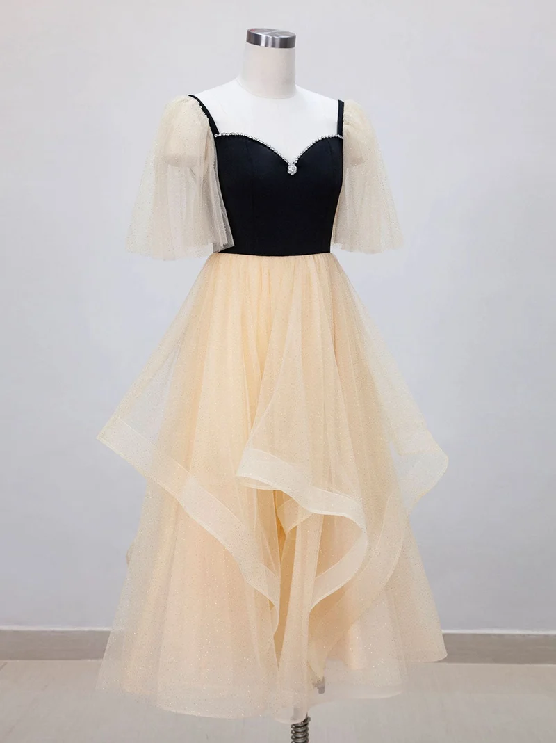 Robe de bal noire avec haut et bas champagne, longueur thé