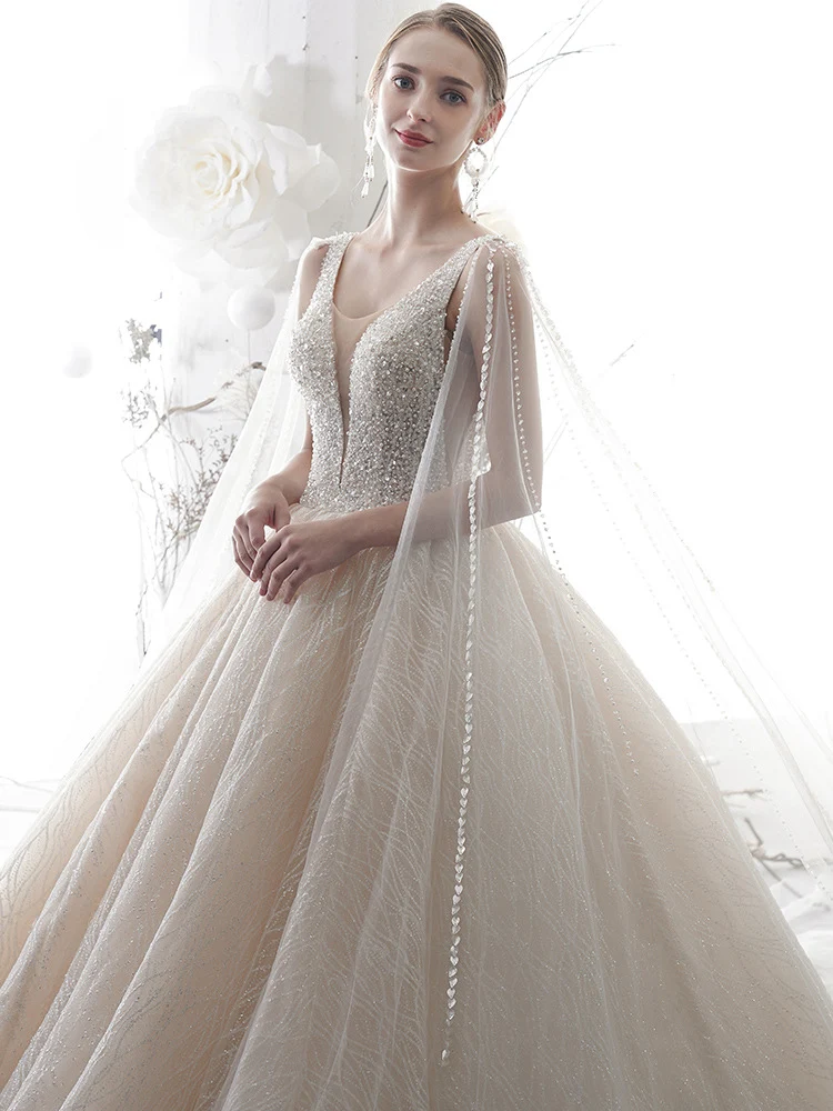 Robe de mariée robe de bal sans manches à col en V et paillettes champagne clair