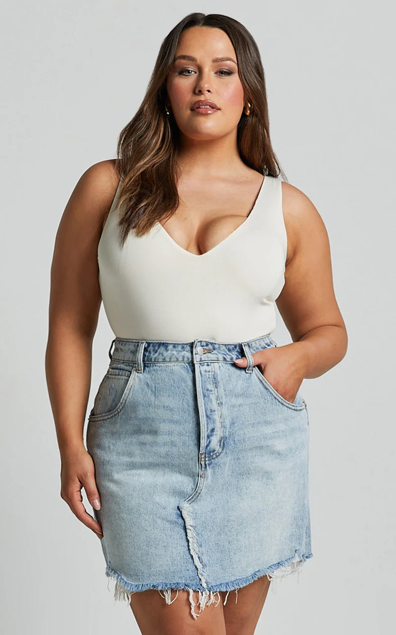 Pieta Mini Skirt - Recycled Cotton Raw Hem Denim Skirt in Mid Blue Wash