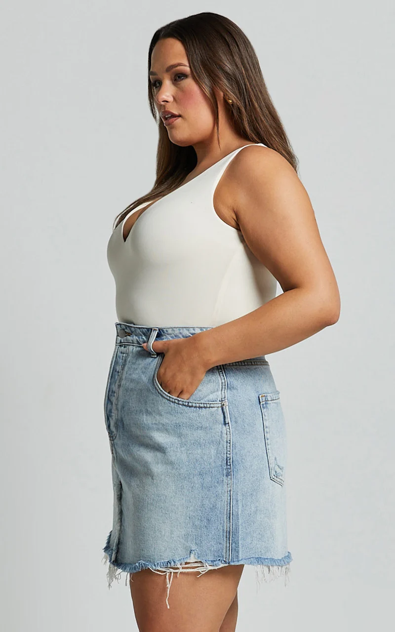 Pieta Mini Skirt - Recycled Cotton Raw Hem Denim Skirt in Mid Blue Wash