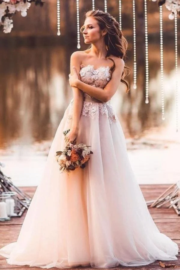 Robe de mariée élégante en tulle, coupe trapèze, décolleté en cœur, avec des appliques en dentelle délicates et une traîne