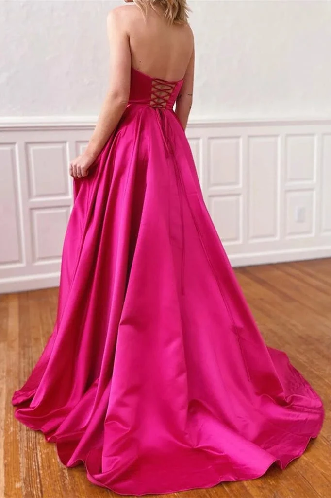 Robe de bal trapèze fuchsia vibrante sans bretelles avec poches et élégante fente latérale