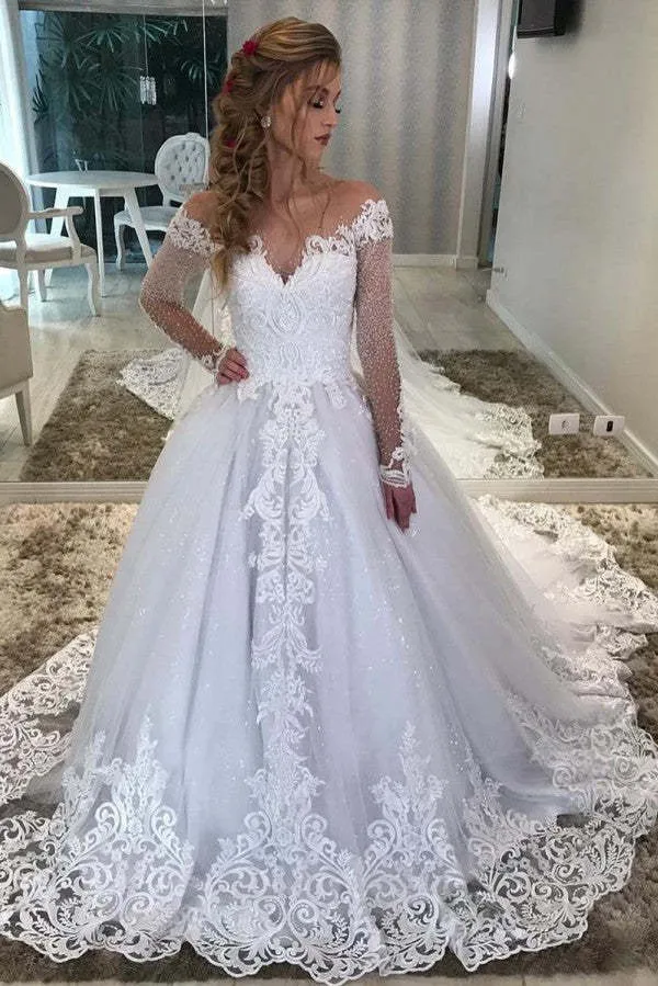 Robe de mariée vintage trapèze, décolleté en cœur, épaules dénudées, manches longues, avec dentelle et paillettes