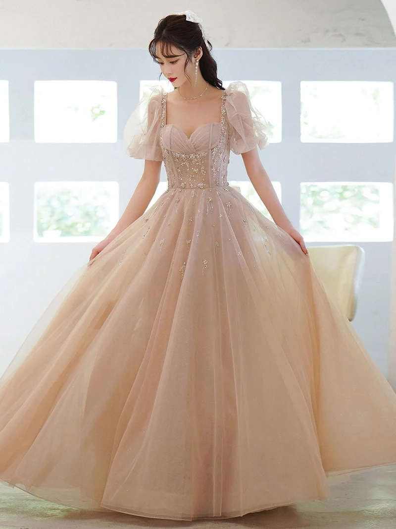 Robe de soirée longue en tulle champagne et perles