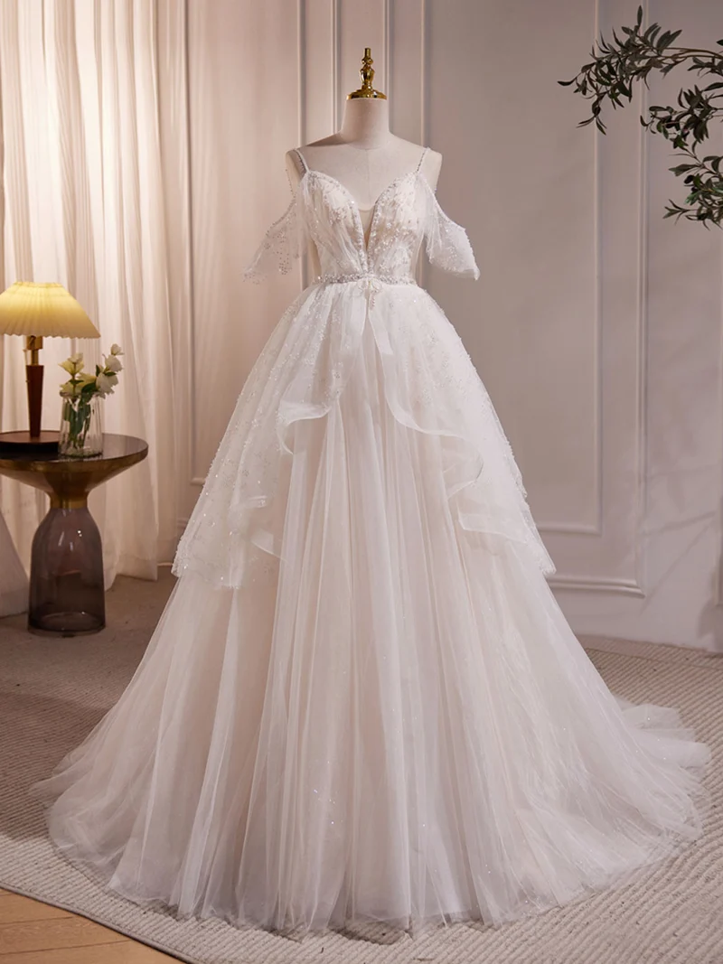 Robe de mariée transparente en tulle avec bretelles spaghetti et épaules dénudées
