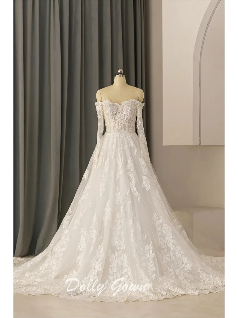 Robe de mariée trapèze en dentelle à épaules dénudées et transparente à manches longues